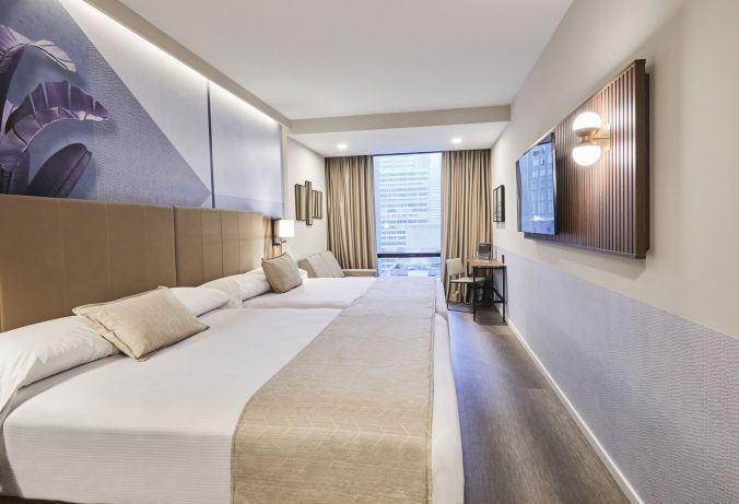 Family-friendly hotel room in New York City with two beds, a pull-out couch, and space for kids