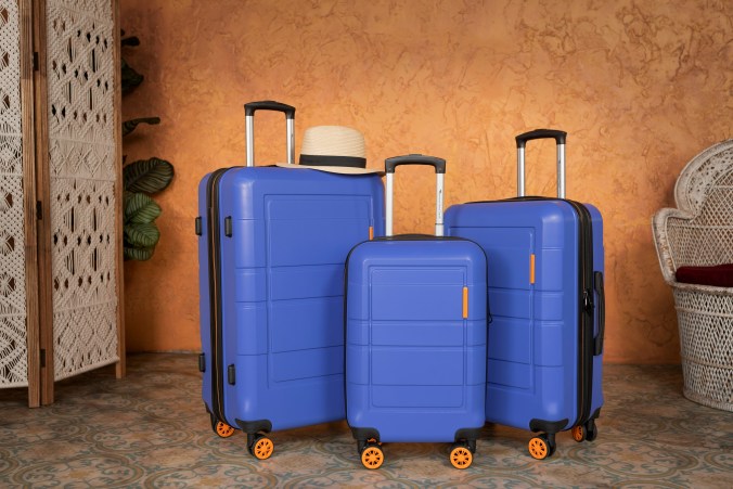 Blue hard-shell suitcases and carry-on luggage for organized family travel