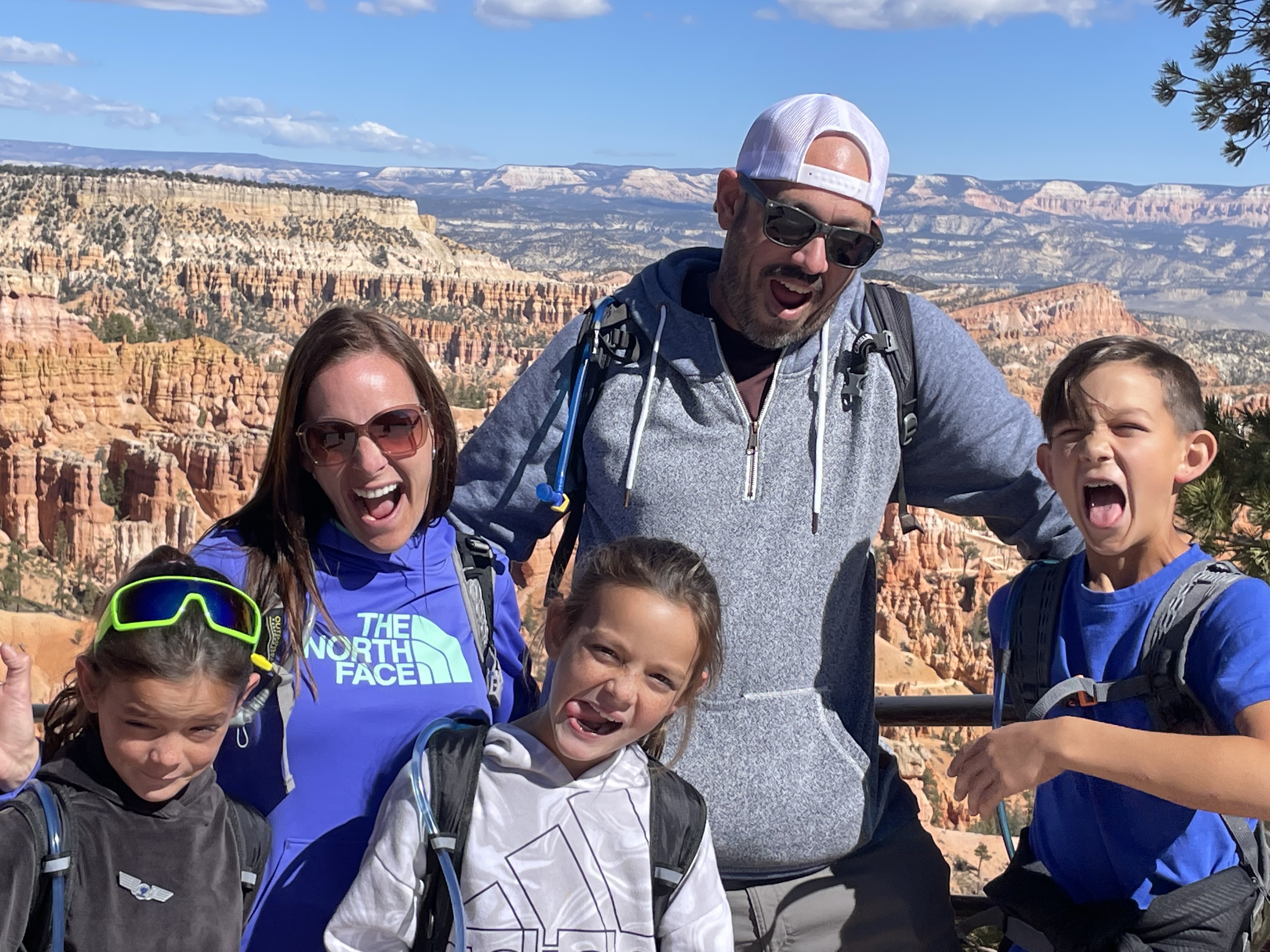 Family smiling and laughing at an overlook in Bryce Canyon National Park
