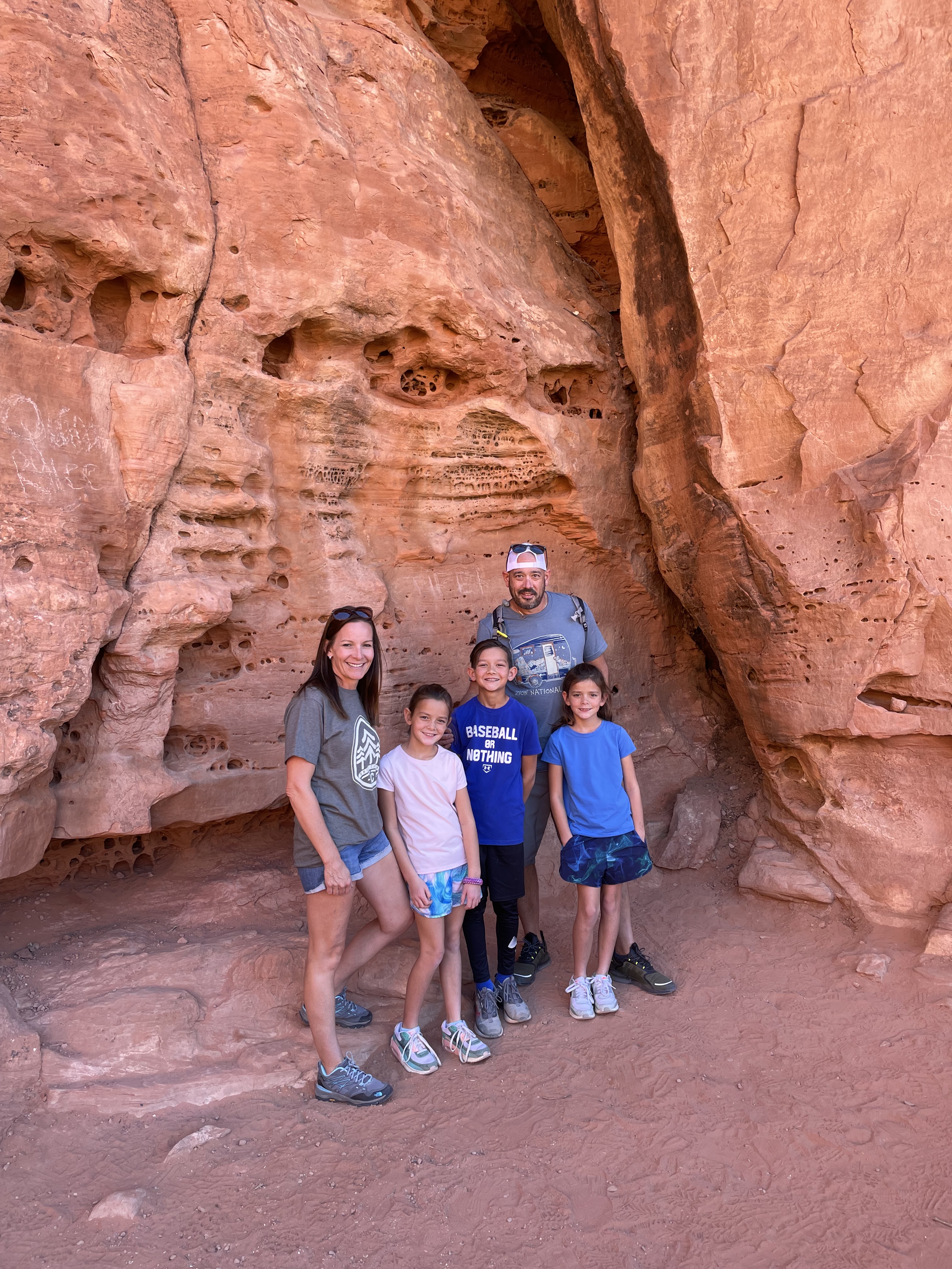Family standing together in a canyon rock formation at Snow Canyon State Park