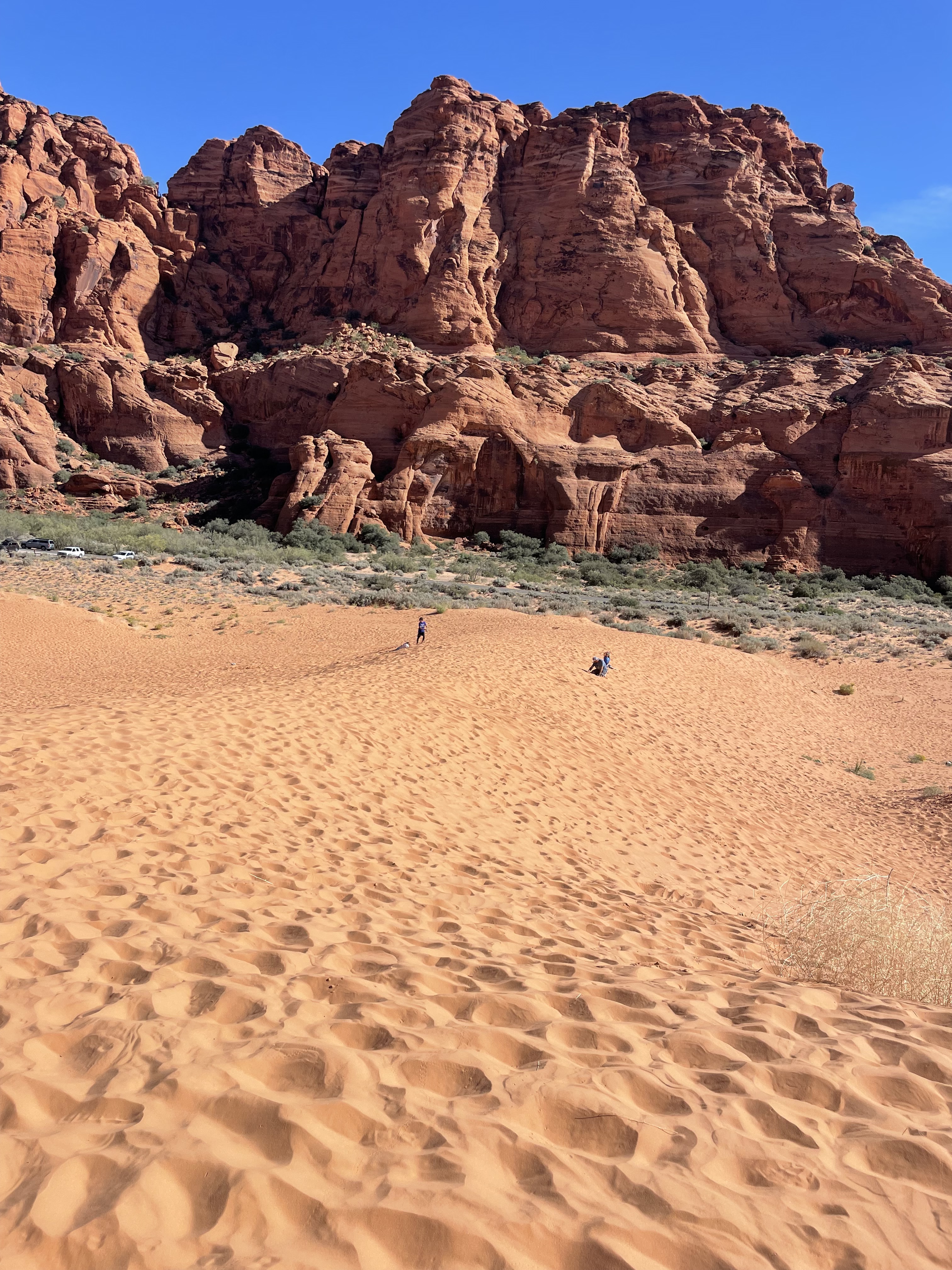 Snow Canyon State Park red sand dunes with rocky cliffs in the background