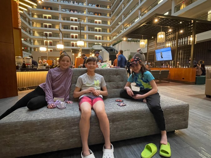 Kids relaxing in a hotel lounge during a family trip break
