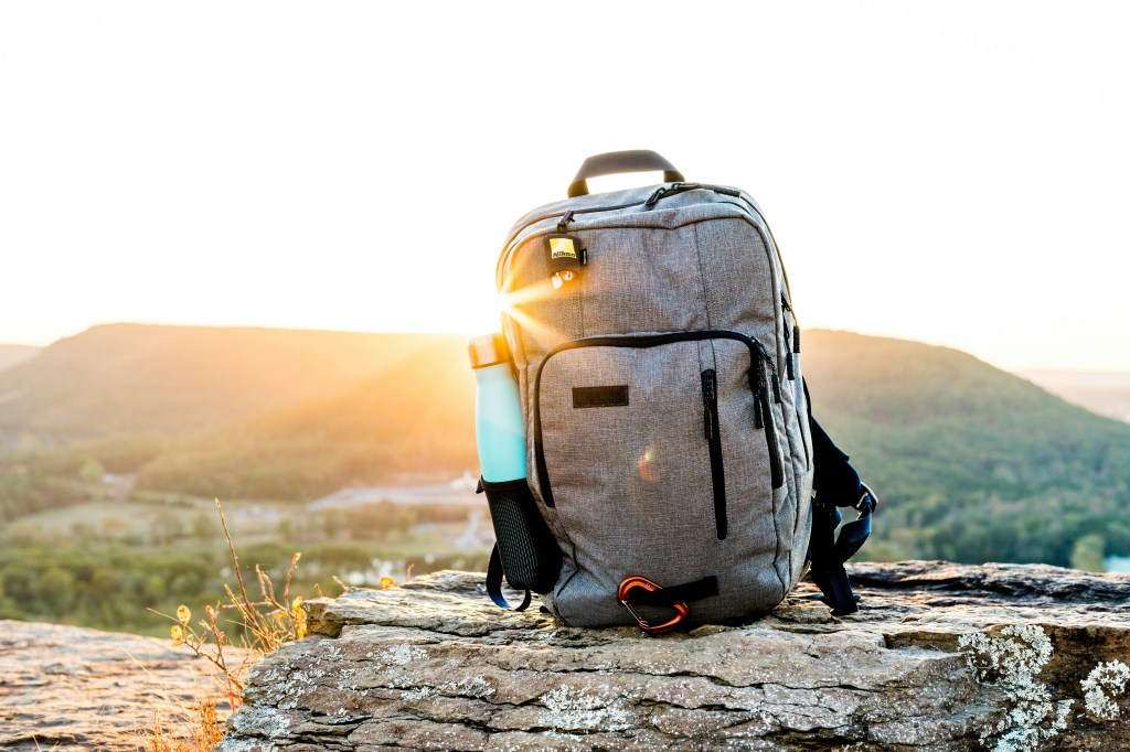 Travel backpack with scenic overlook view representing packing light for travel