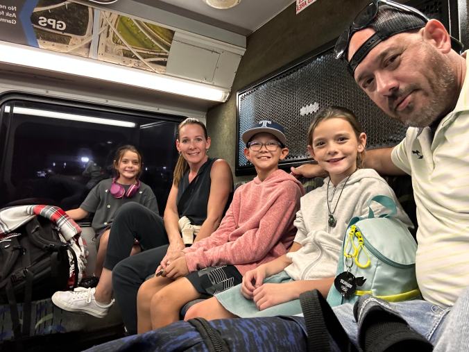Family sitting together on public transportation during travel