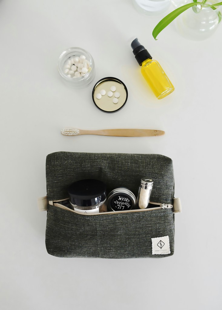 Travel toiletry essentials including small containers and personal care items organized in pouch