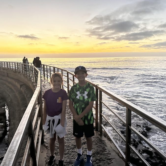 La Jolla Cove at sunset with ocean cliffs and colorful sky in San Diego California