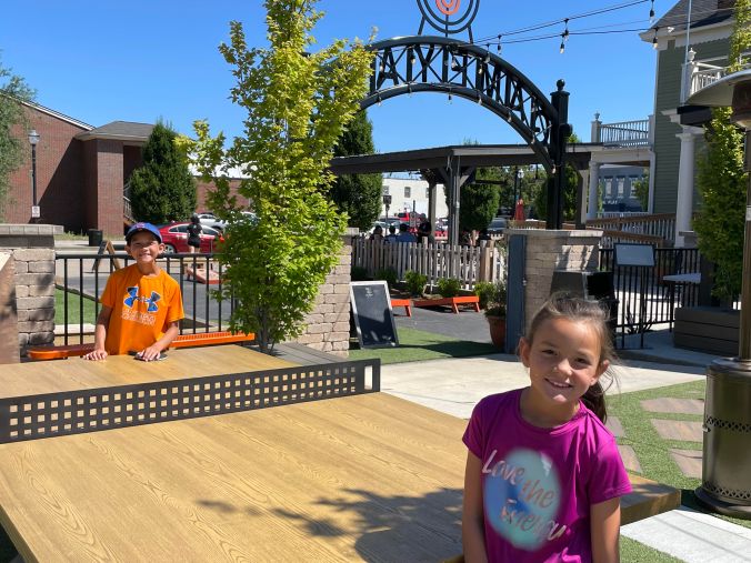 Child standing outside The Game Yard entertainment and restaurant area in Louisville, Kentucky.