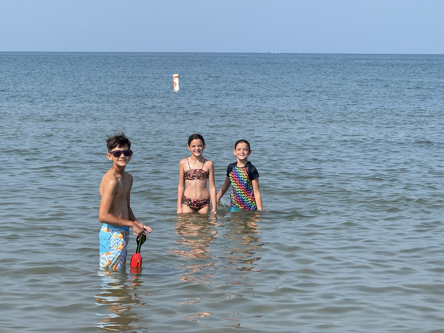South Beach in South Haven With Kids Kids swimming in Lake Michigan at South Beach in South Haven, Michigan on a sunny summer day.