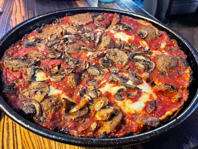 Deep dish pizza with mushrooms and sausage at Pequod’s Pizza in Chicago
