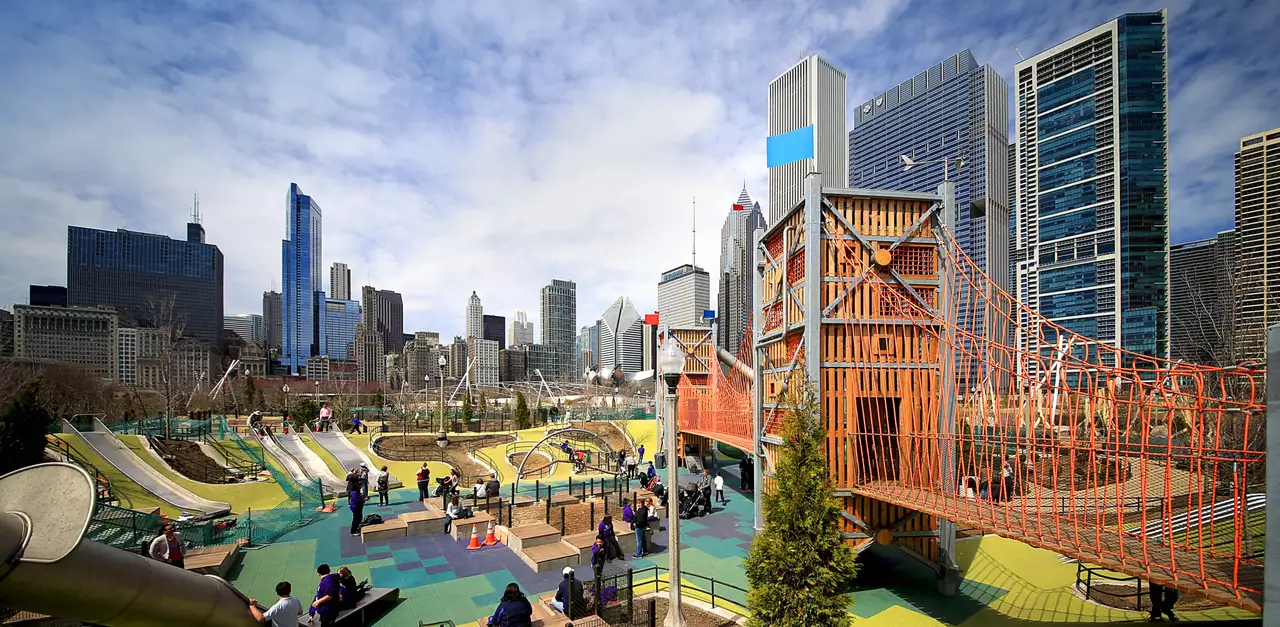 Colorful playground and climbing structures at Maggie Daley Park in downtown Chicago with skyline views