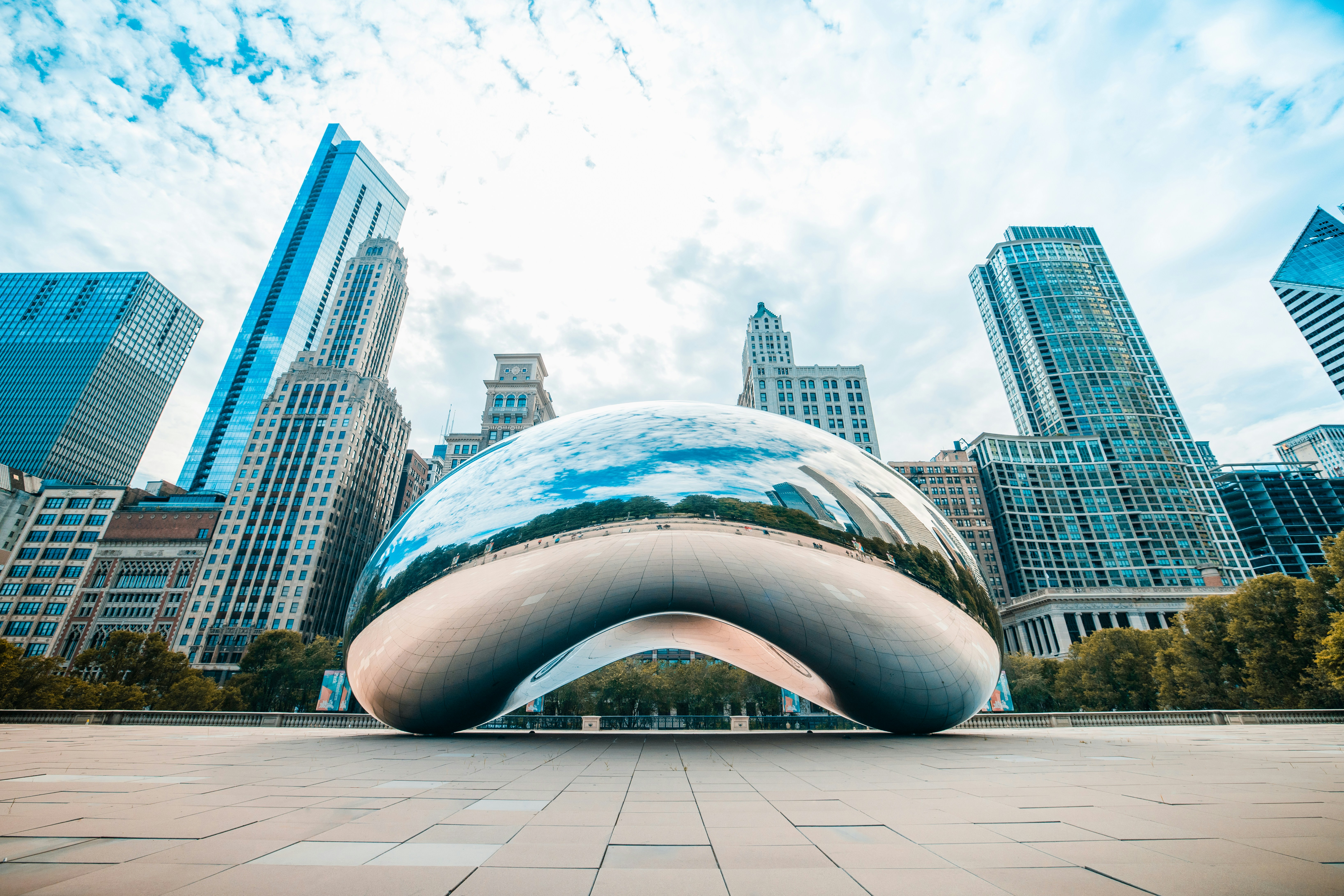 Cloud Gate The Bean in Millennium Park with the Chicago skyline in the background