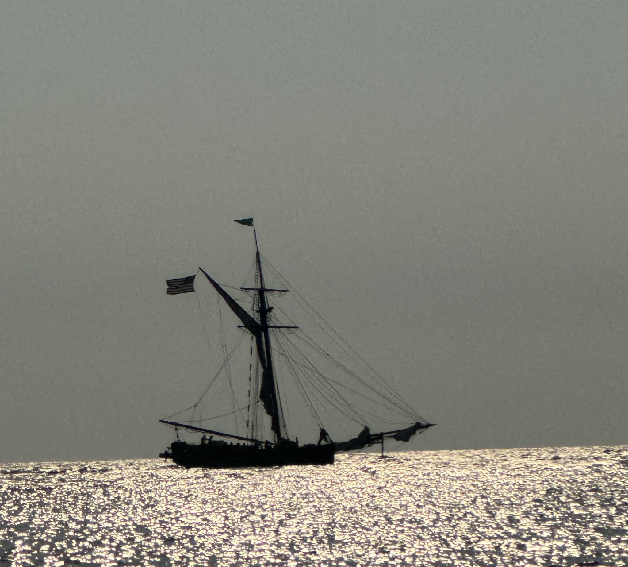 Sailboat Sunset in South Haven, Michigan Historic-style sailboat silhouetted on sparkling Lake Michigan water near South Haven, Michigan during sunset.