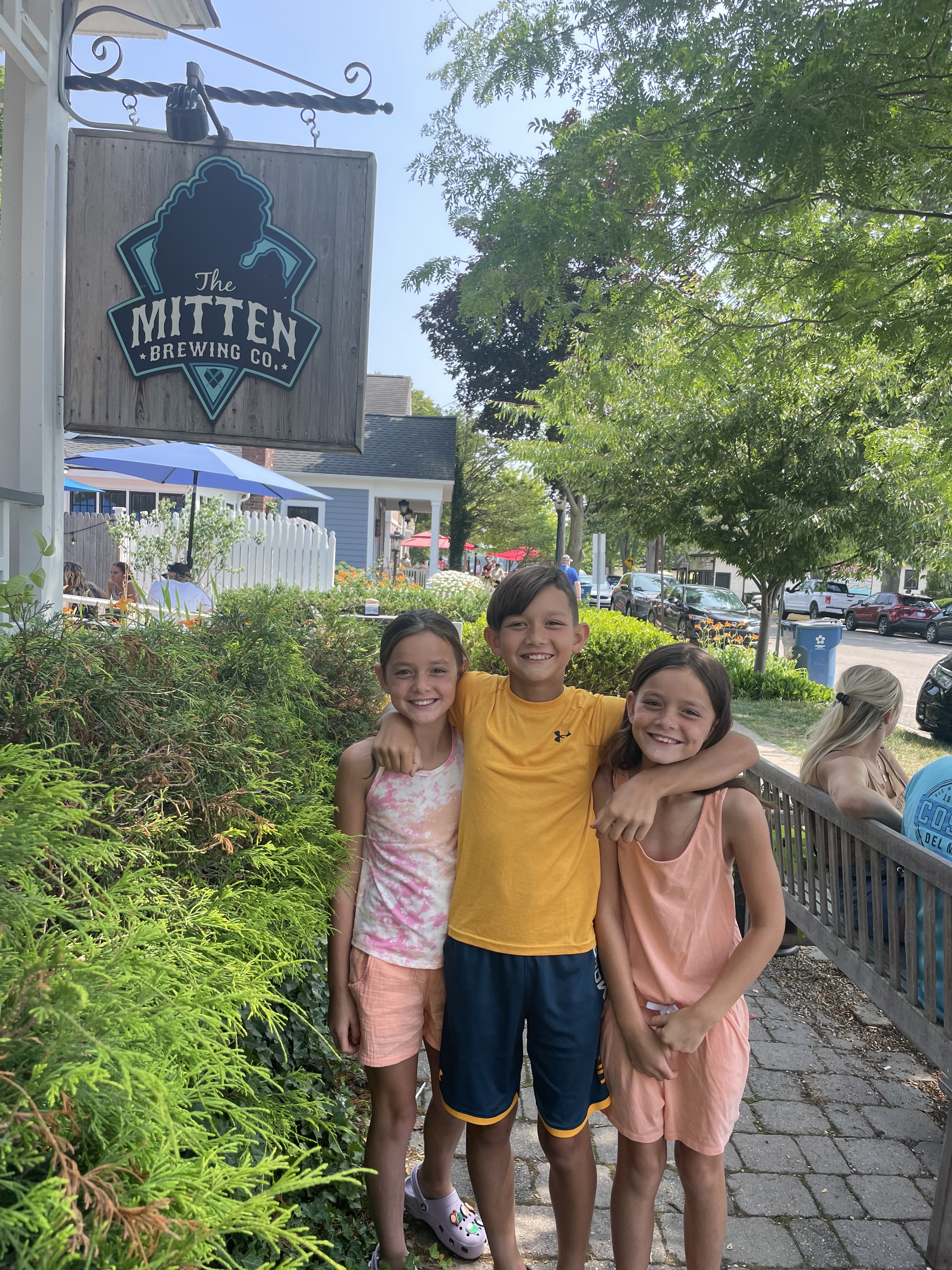 Kids standing outside The Mitten Brewing Company in downtown Saugatuck Michigan