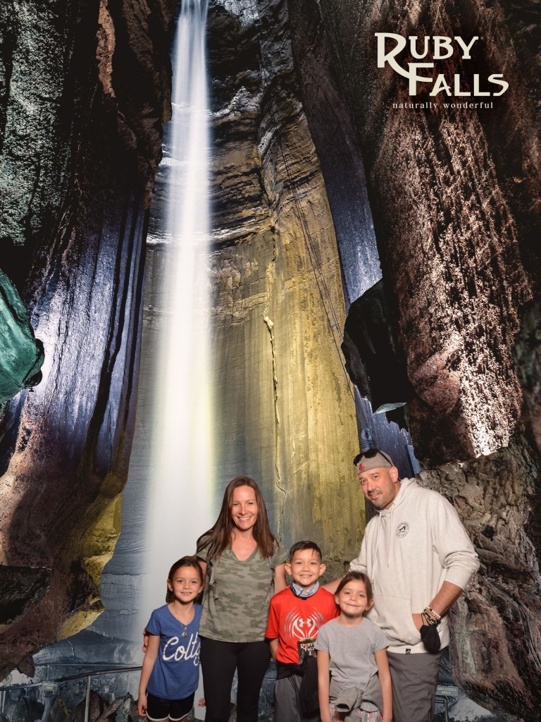 Family standing inside Ruby Falls cave near the underground waterfall on Lookout Mountain in Chattanooga Tennessee