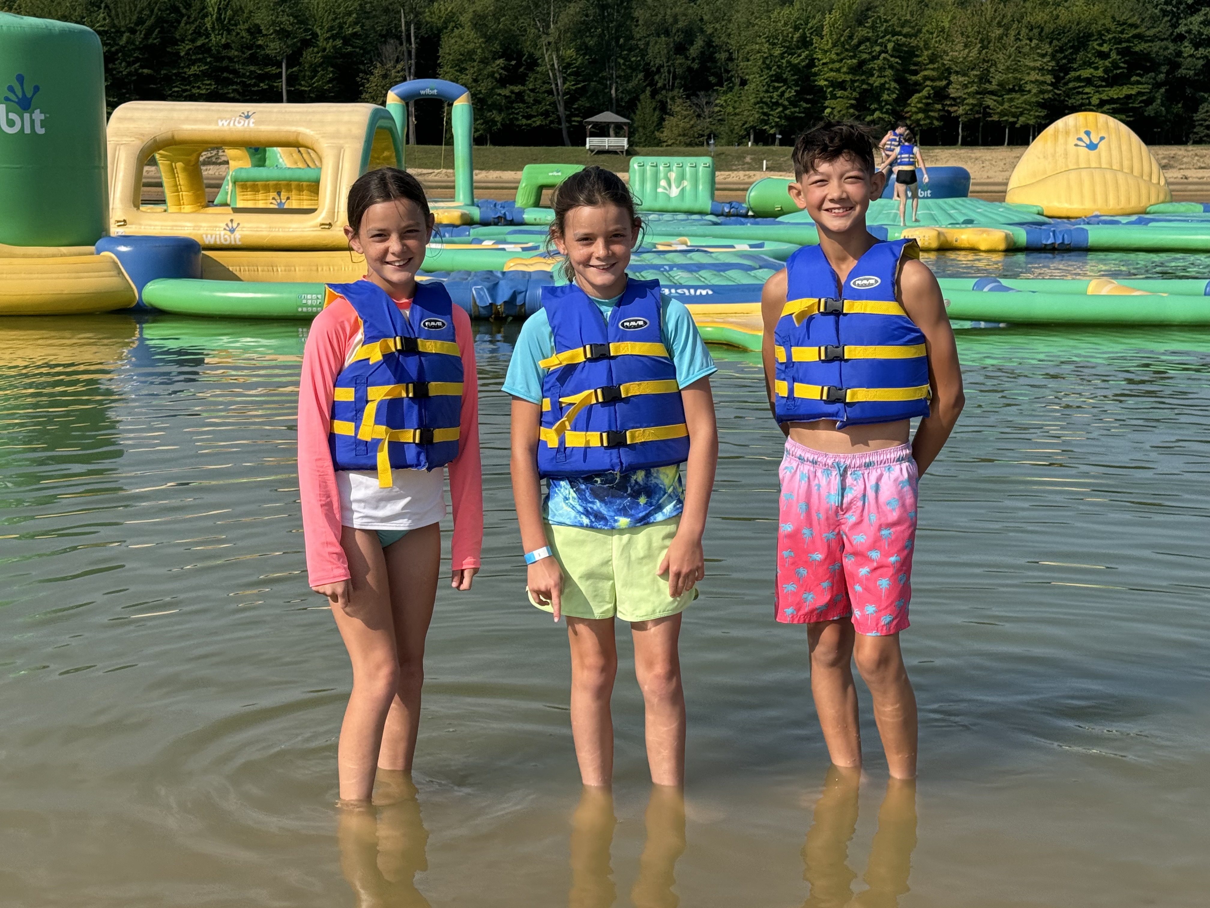 Lake Arvesta Farms Inflatable Water Park Kids wearing life jackets at the inflatable water park at Lake Arvesta Farms near South Haven, Michigan.