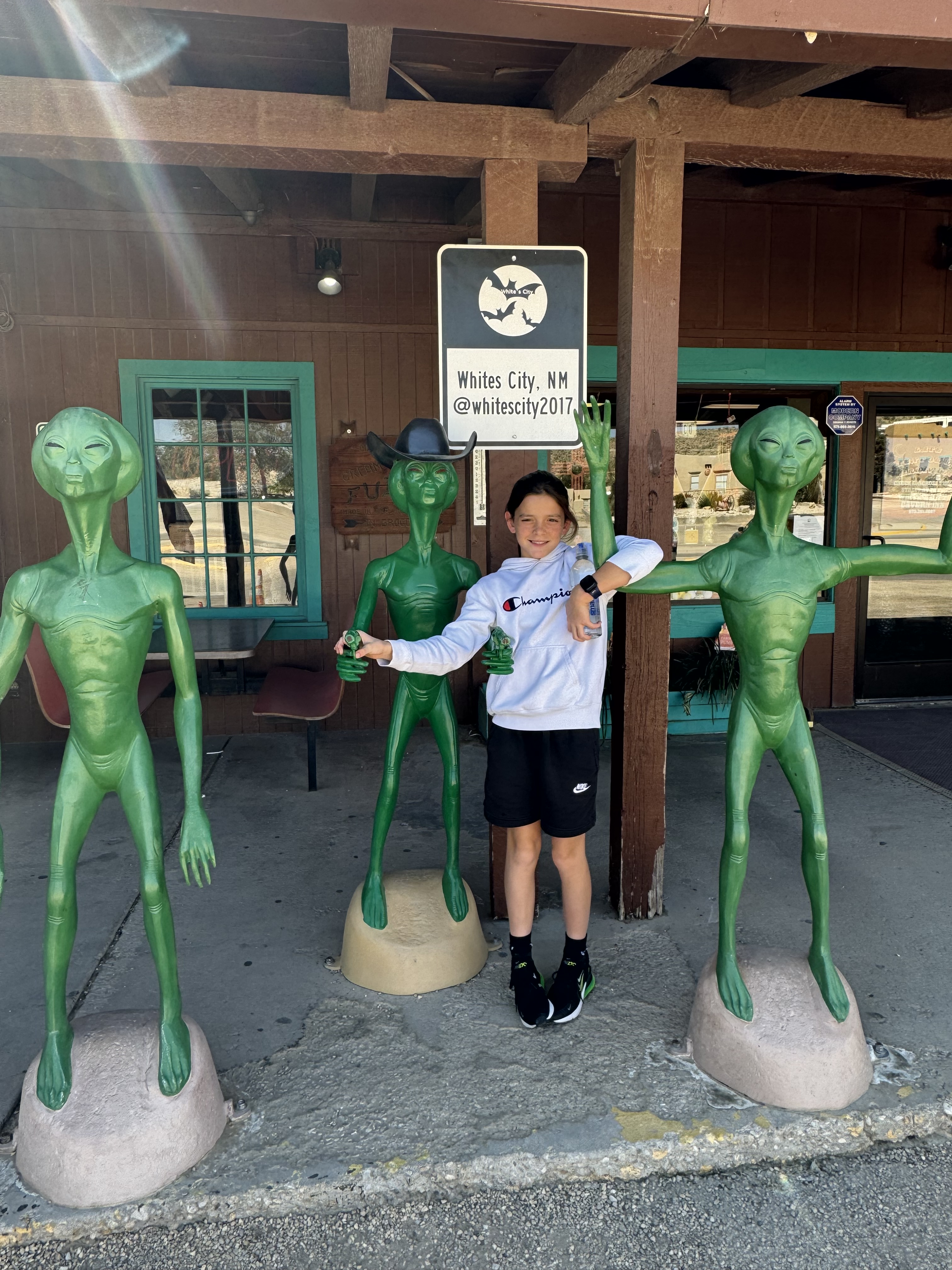 Child posing with alien statues in Roswell New Mexico