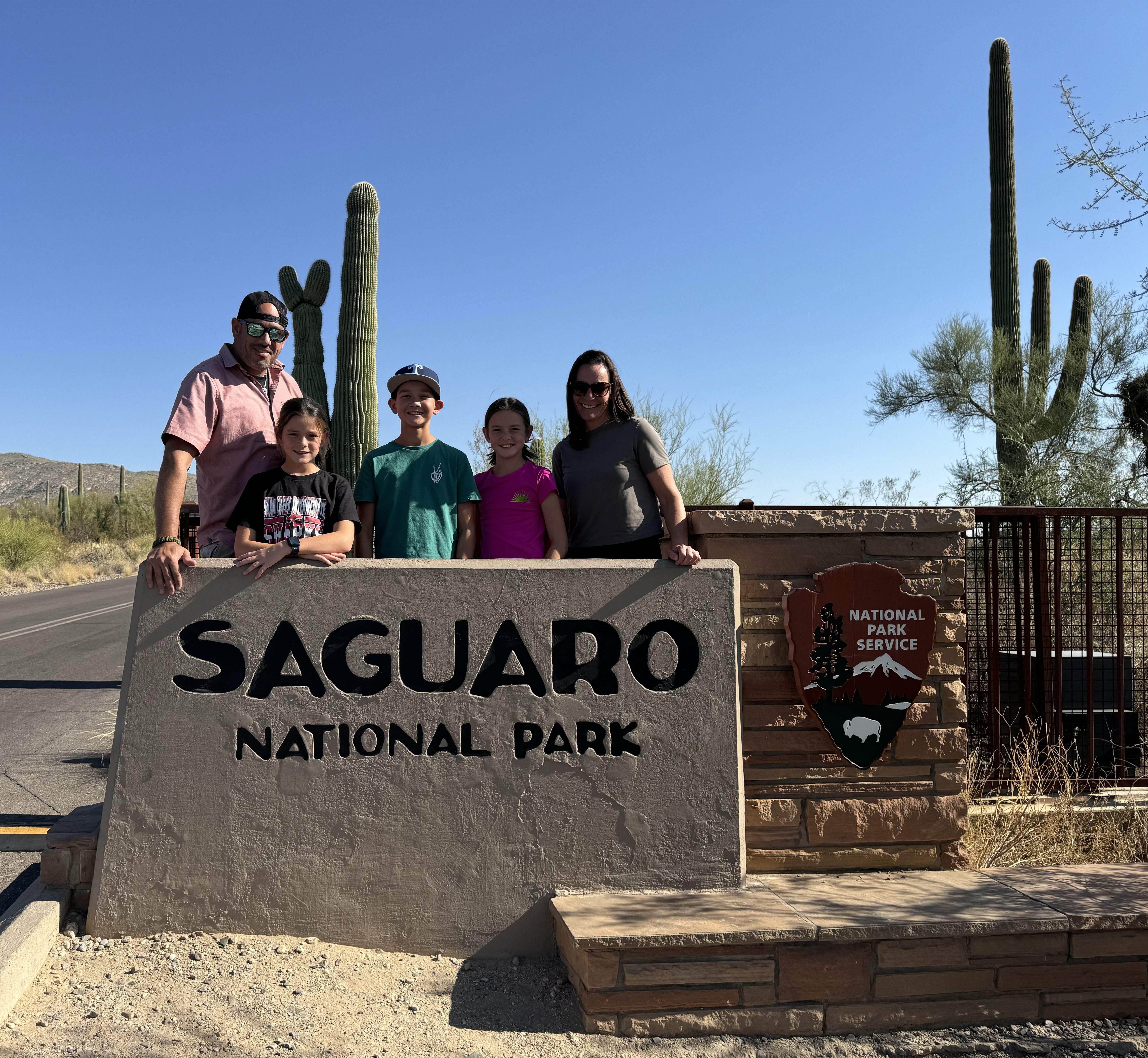 Family visiting Saguaro National Park in Tucson Arizona with giant cactus views