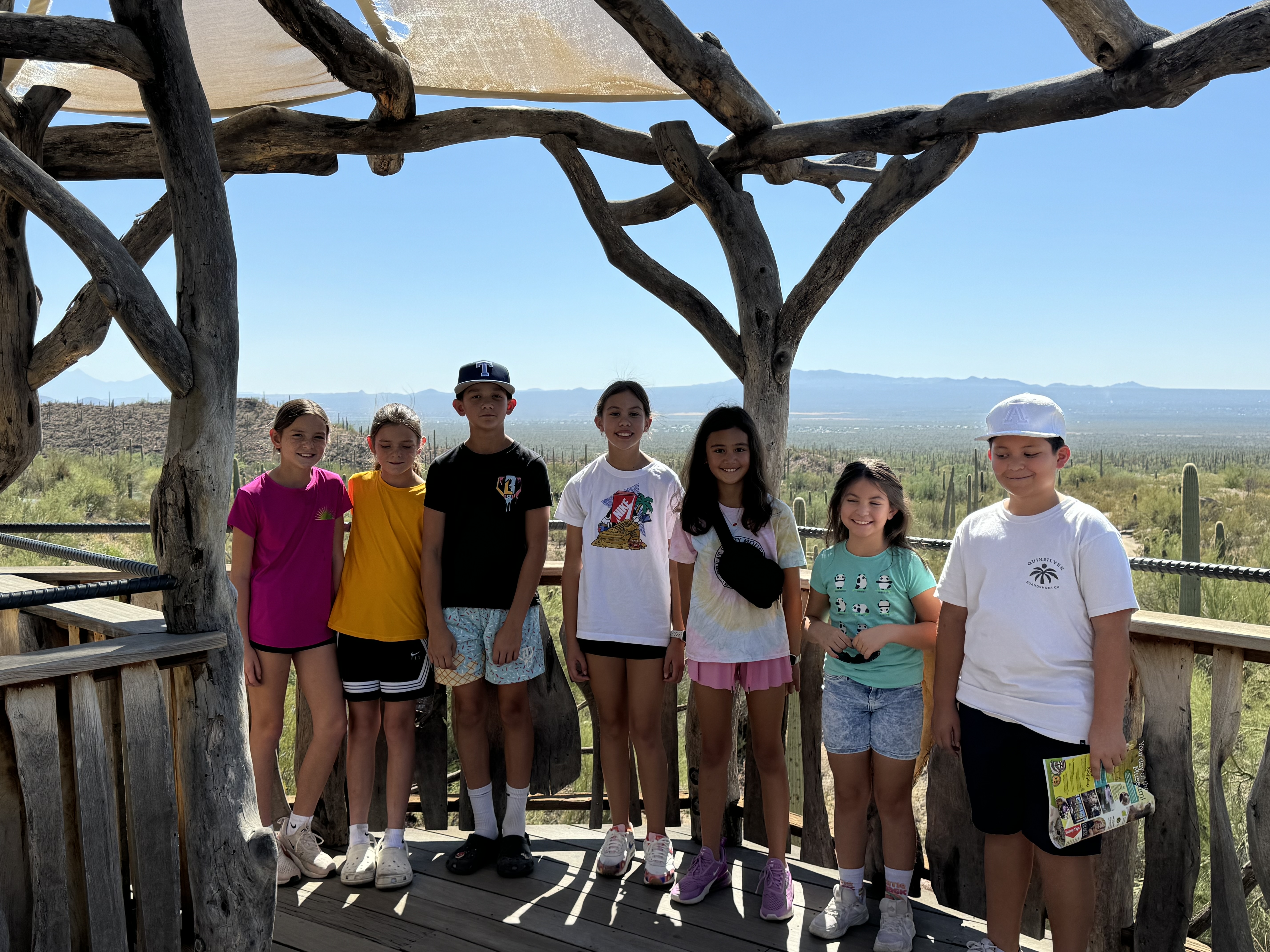 Family visiting the Arizona-Sonora Desert Museum in Tucson Arizona with desert animals and cactus scenery