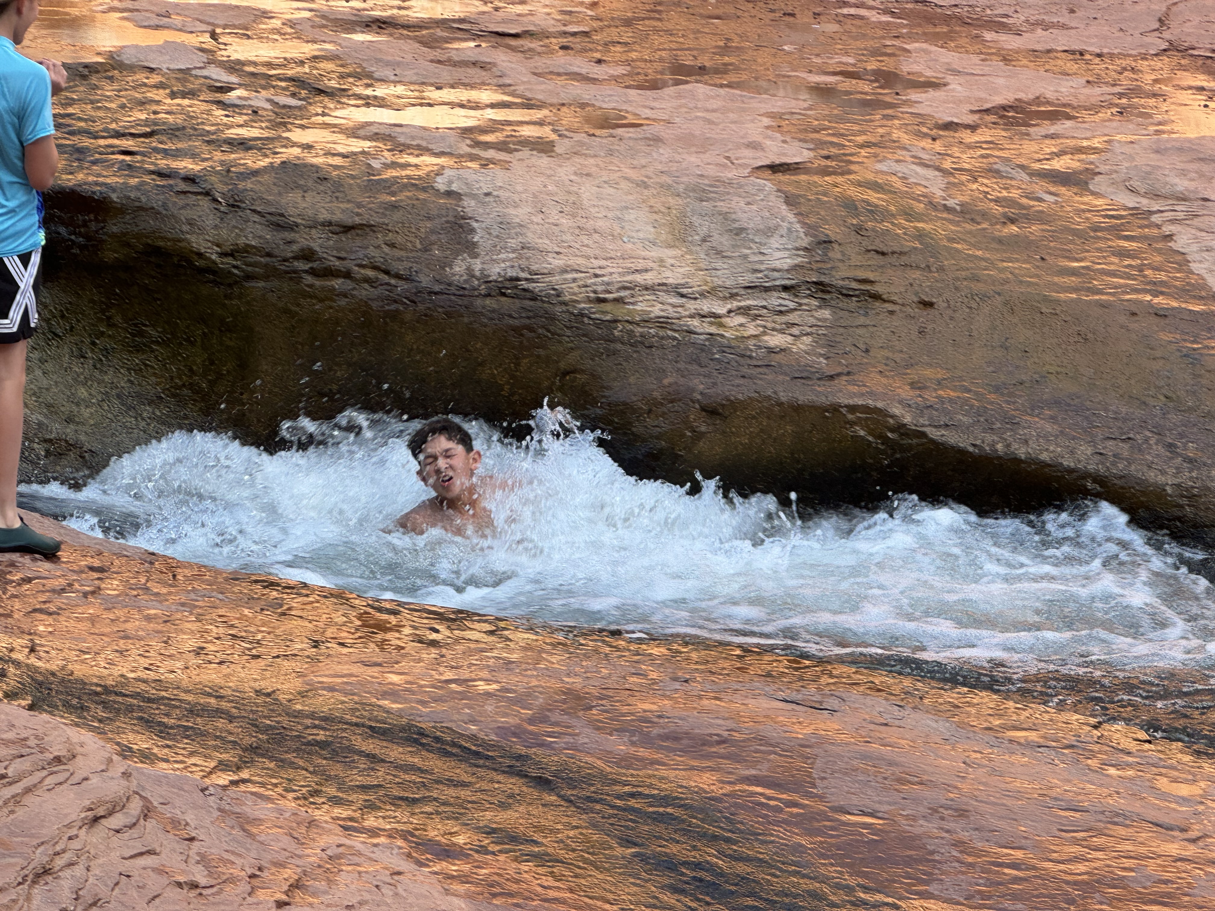 Kids sliding through water at Slide Rock State Park Sedona