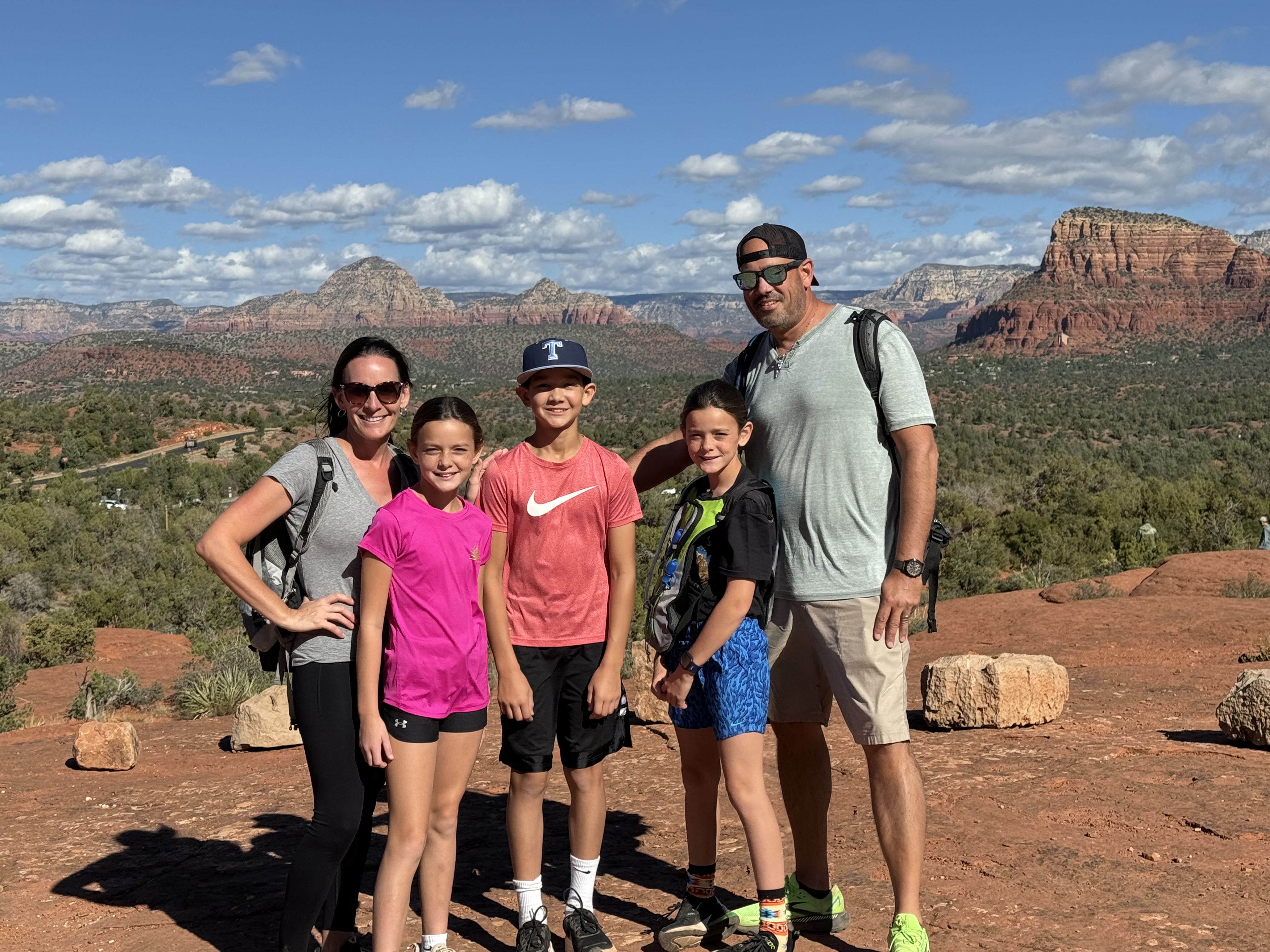 Family hiking in Sedona with kids surrounded by red rock views in Arizona