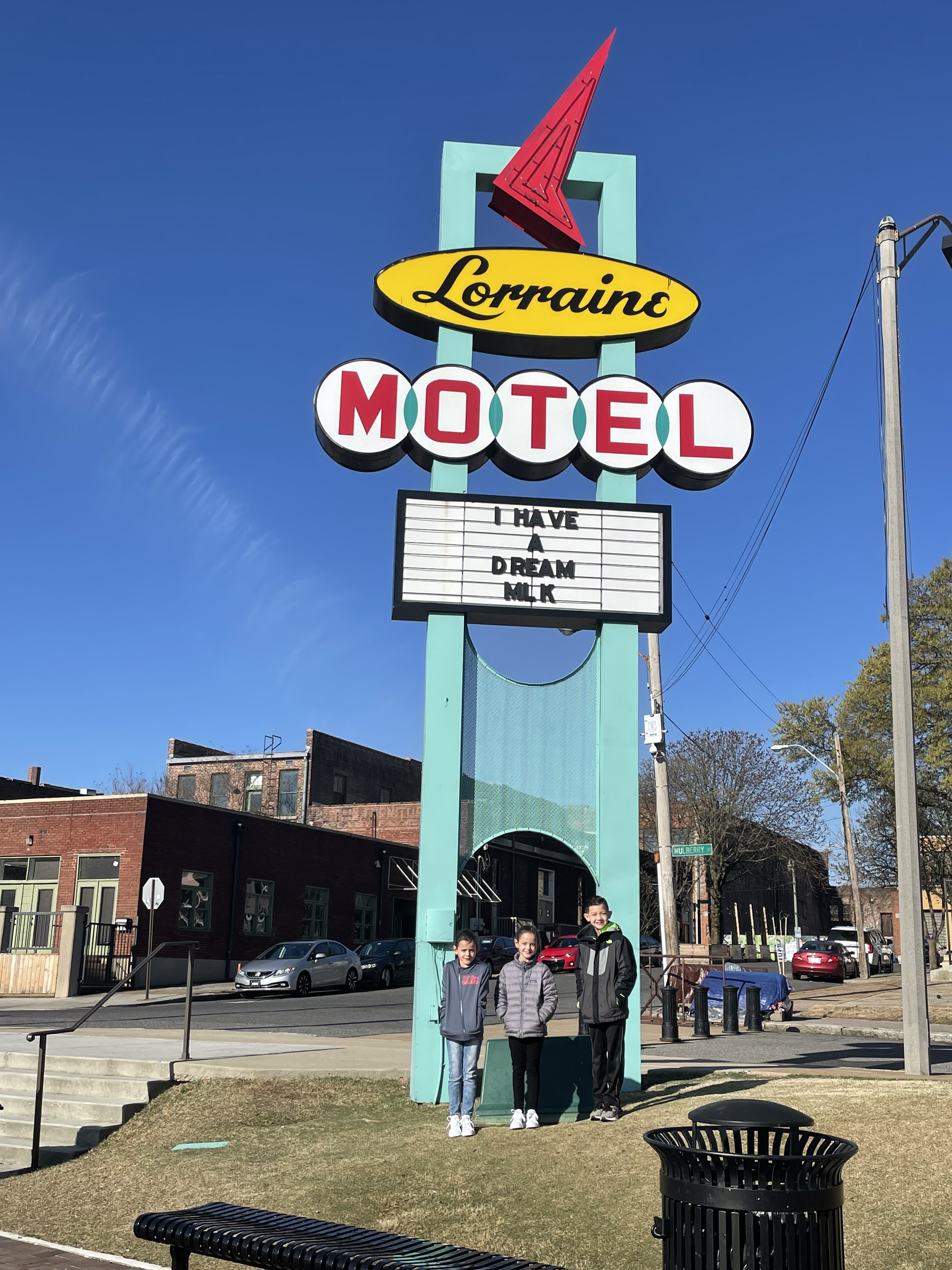 Kids standing beneath the Lorraine Motel sign at the National Civil Rights Museum in Memphis