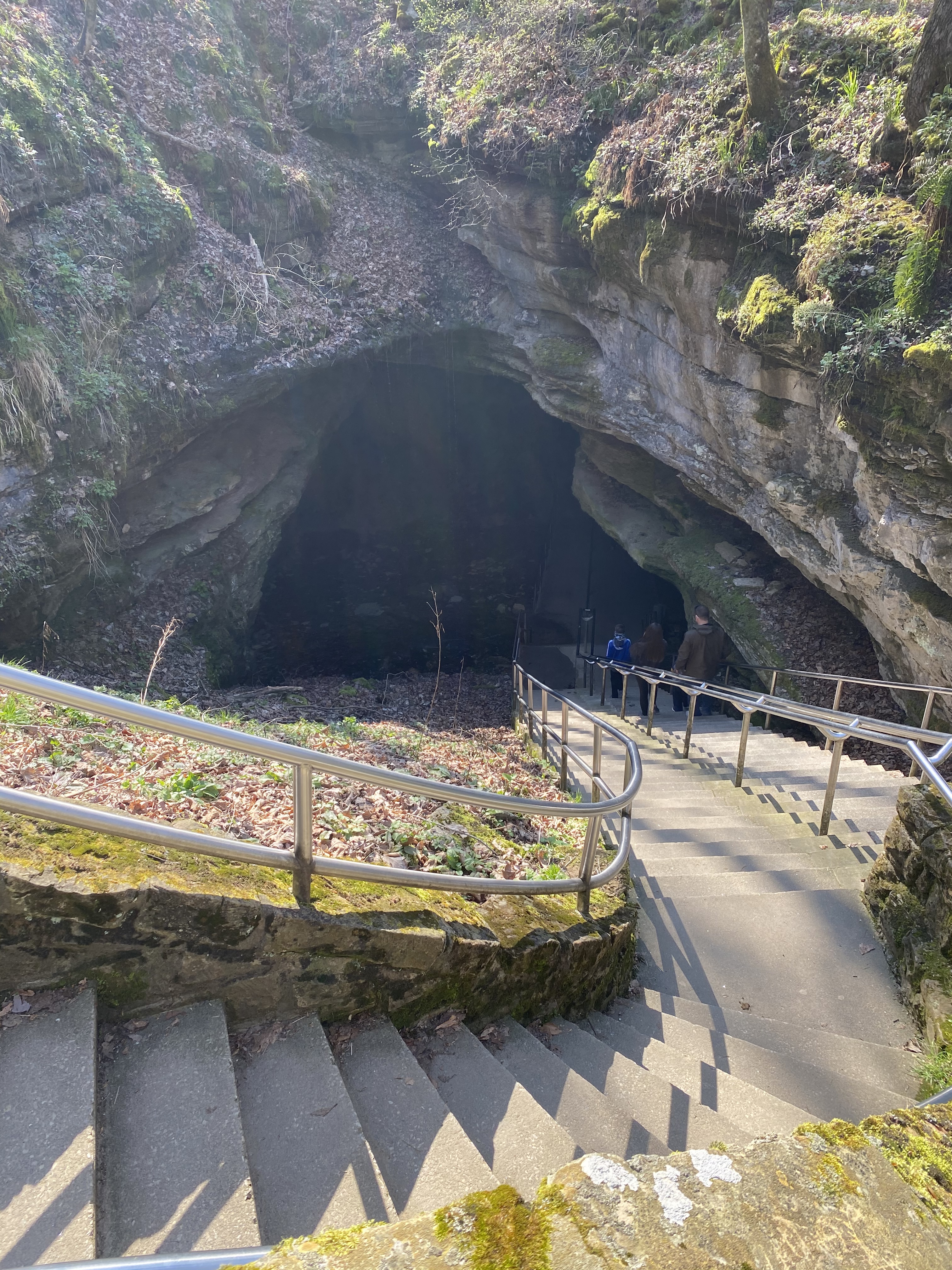 Visitors walking through the massive entrance of Mammoth Cave National Park in Kentucky