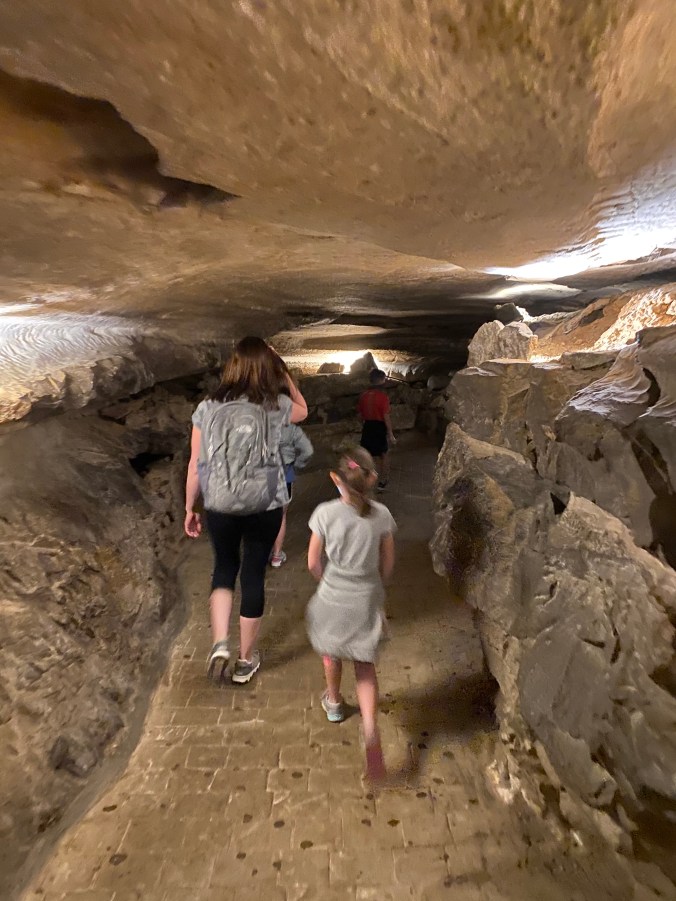 Family walking through the underground cave pathway during the Ruby Falls tour in Chattanooga, Tennessee.