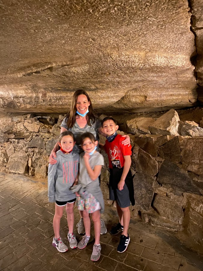 Mom and kids posing inside the underground cave passage during the Ruby Falls tour in Chattanooga, Tennessee.