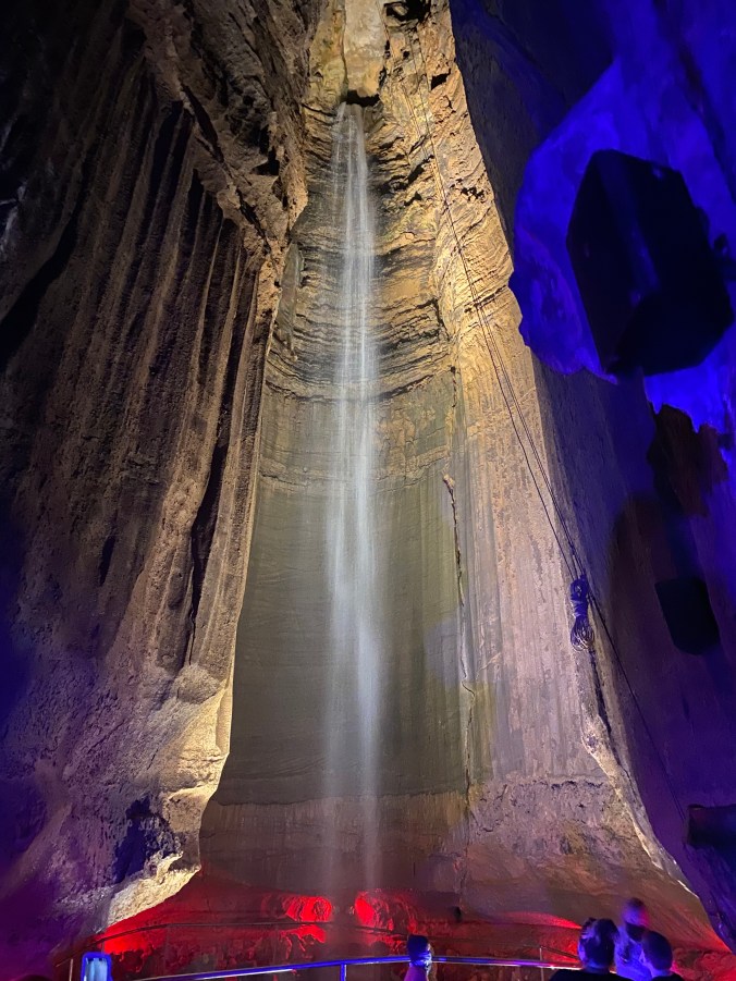 Ruby Falls underground waterfall illuminated with colorful lighting inside a towering cave chamber in Chattanooga, Tennessee.