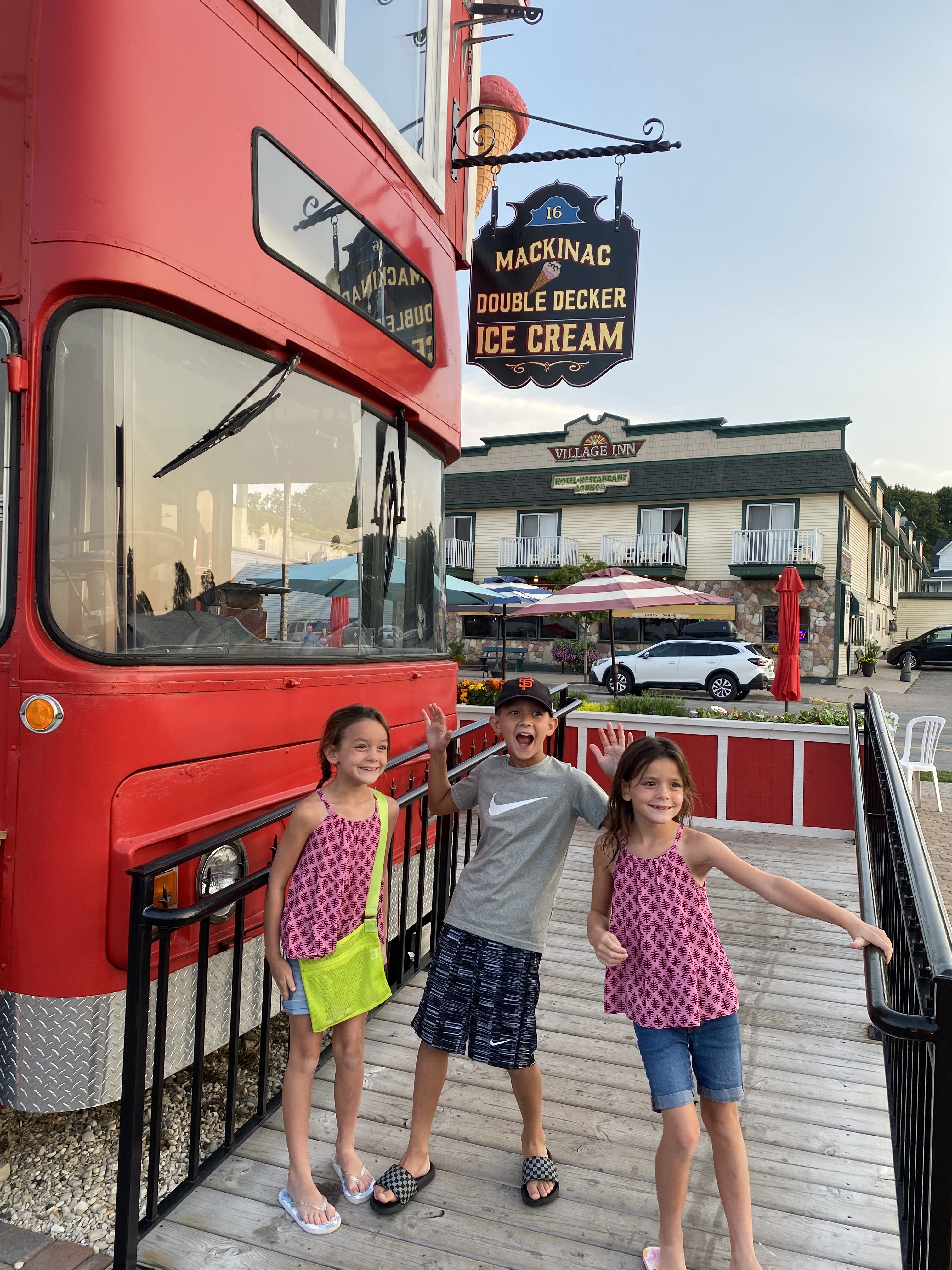 Kids standing near the Mackinac Double Decker Ice Cream bus on Mackinac Island