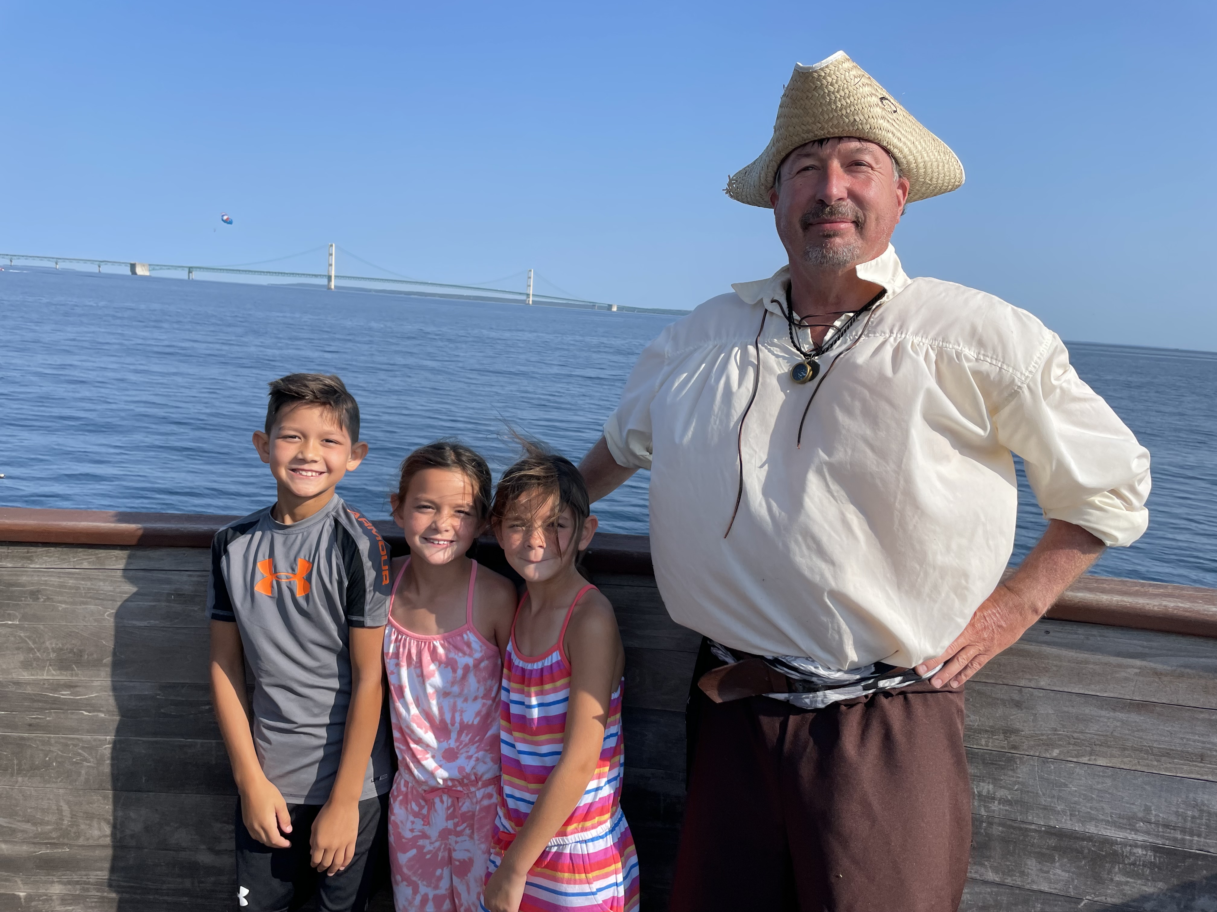 Kids standing with a costumed pirate near the Mackinac Bridge in St Ignace Michigan