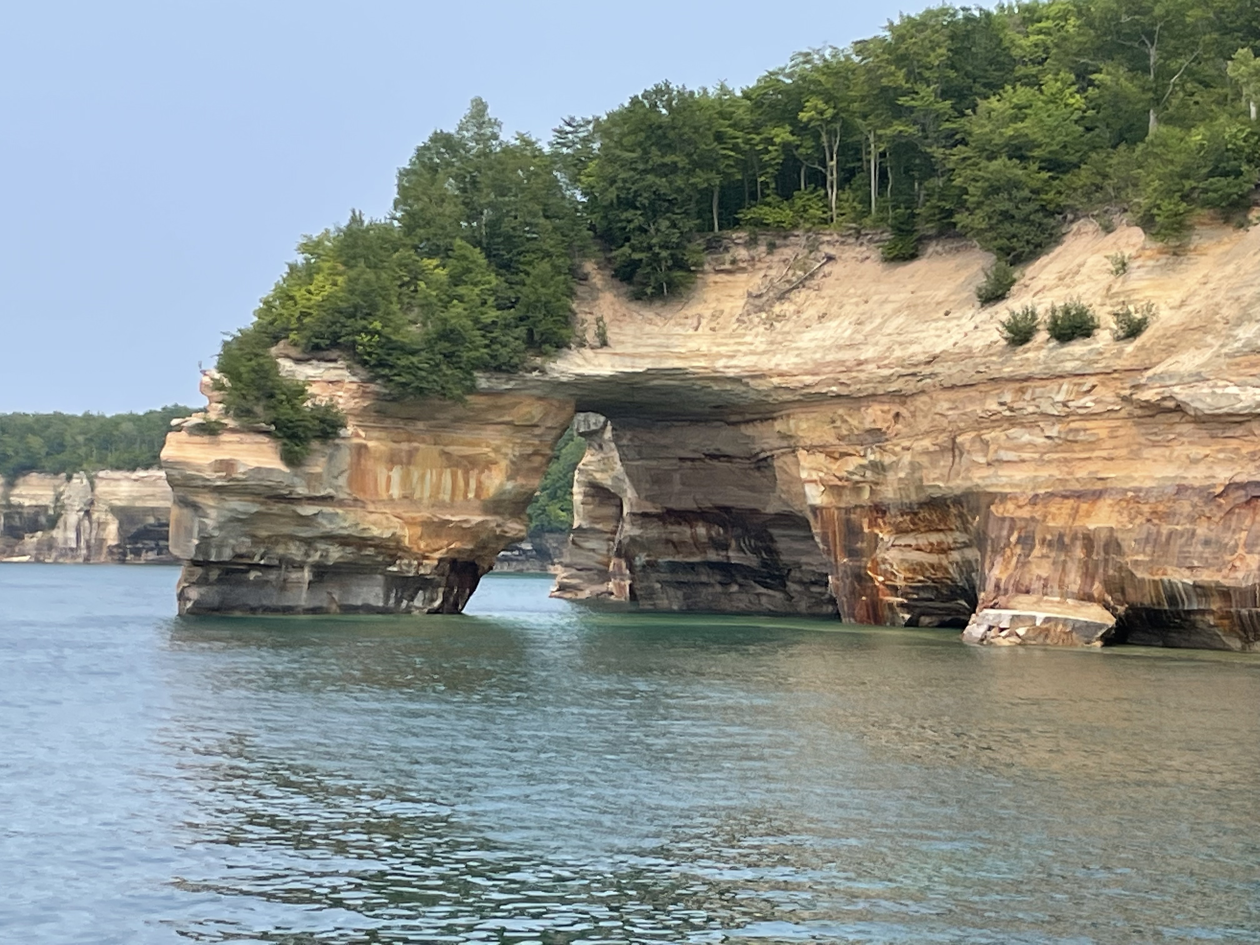 Pictured Rocks sandstone cliffs and emerald green Lake Superior water on a family boat tour in Michigan