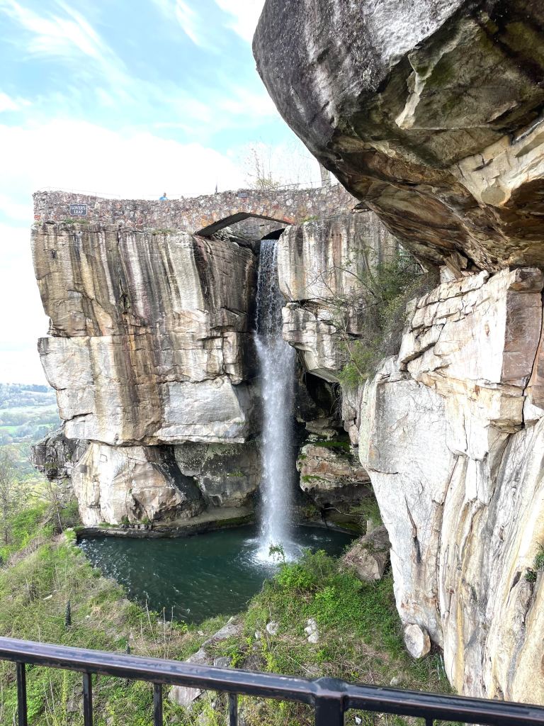 Waterfall flowing beside a stone bridge at Rock City Gardens on Lookout Mountain in Tennessee