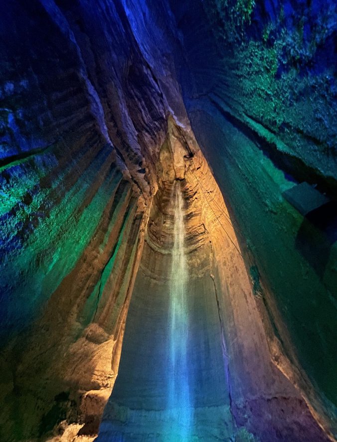 Underground waterfall inside Ruby Falls cave in Chattanooga, Tennessee with colorful blue and purple lighting
