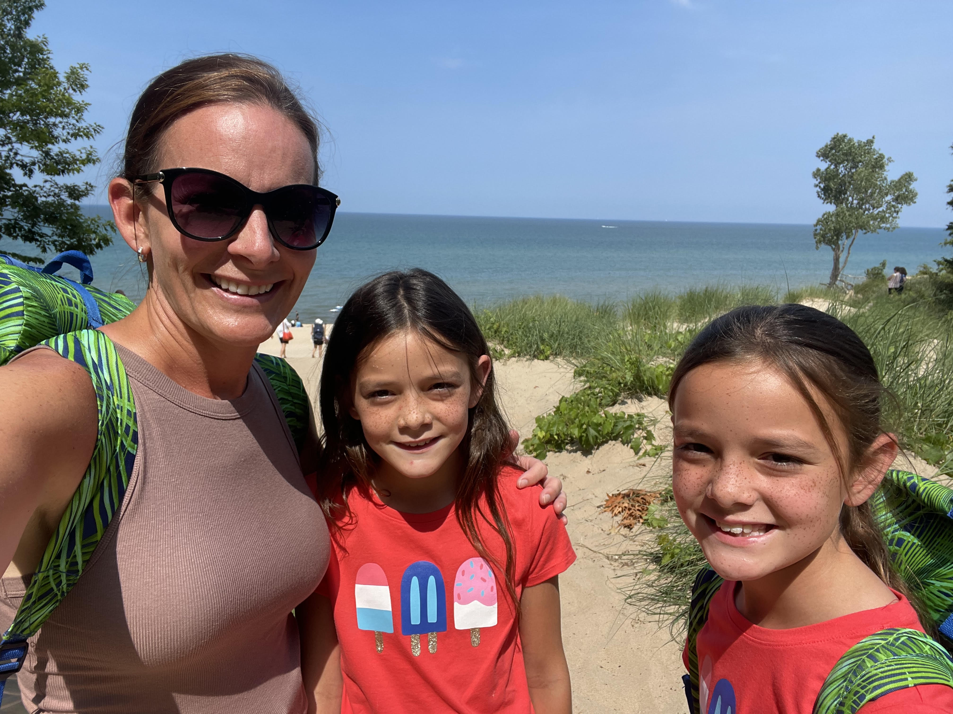 Lake Michigan beach view near Saugatuck with sand dunes and families enjoying the water