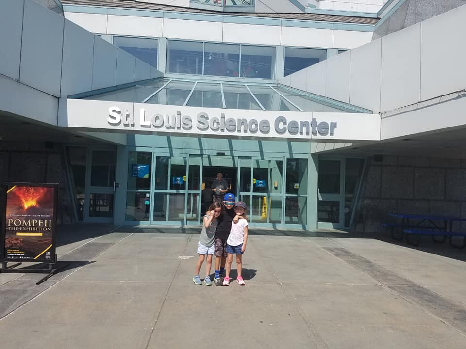 Children standing outside the St. Louis Science Center entrance
