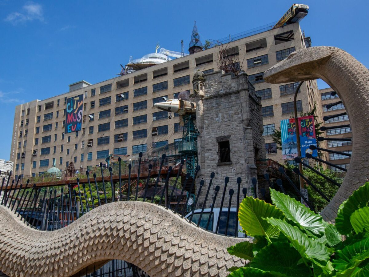 Exterior of City Museum in downtown St. Louis featuring rooftop attractions, climbing structures, and the famous airplane display
