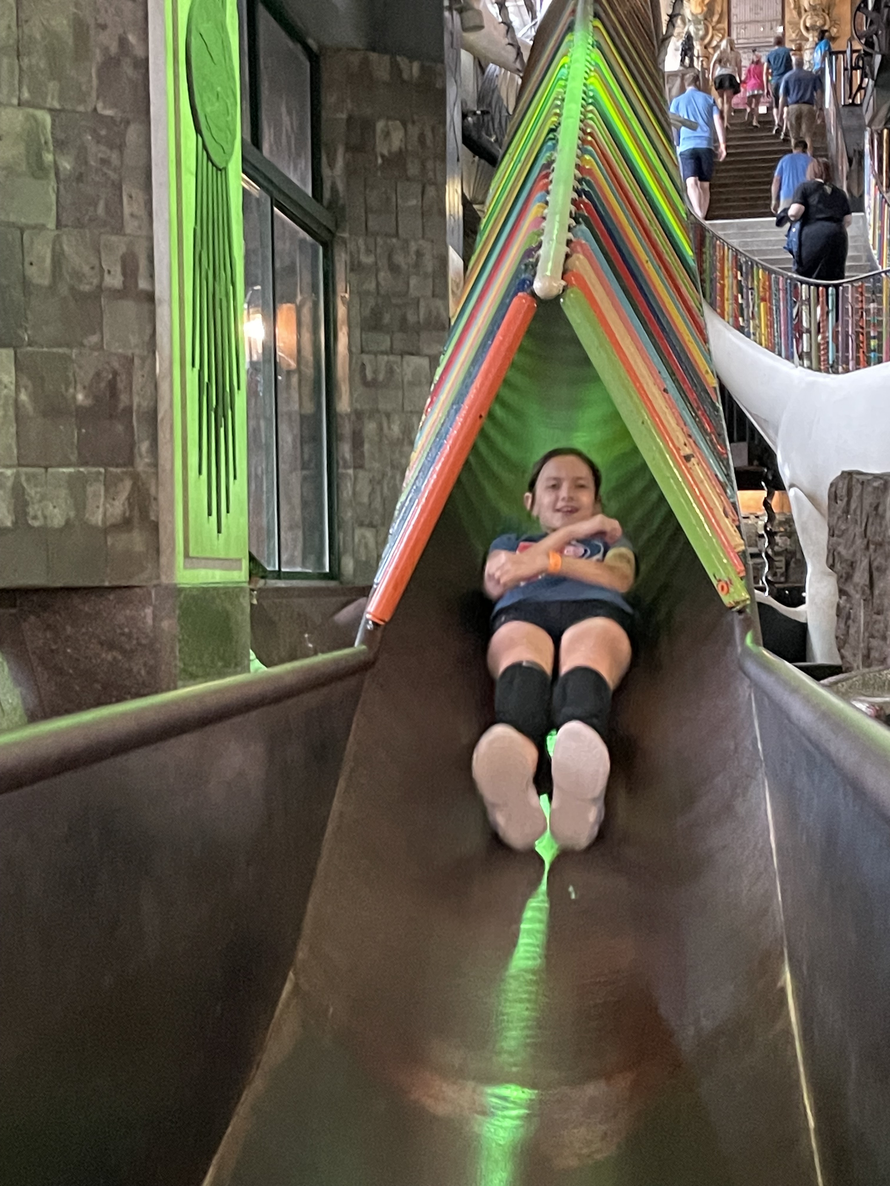 Child sliding down a colorful slide inside City Museum in St. Louis Missouri