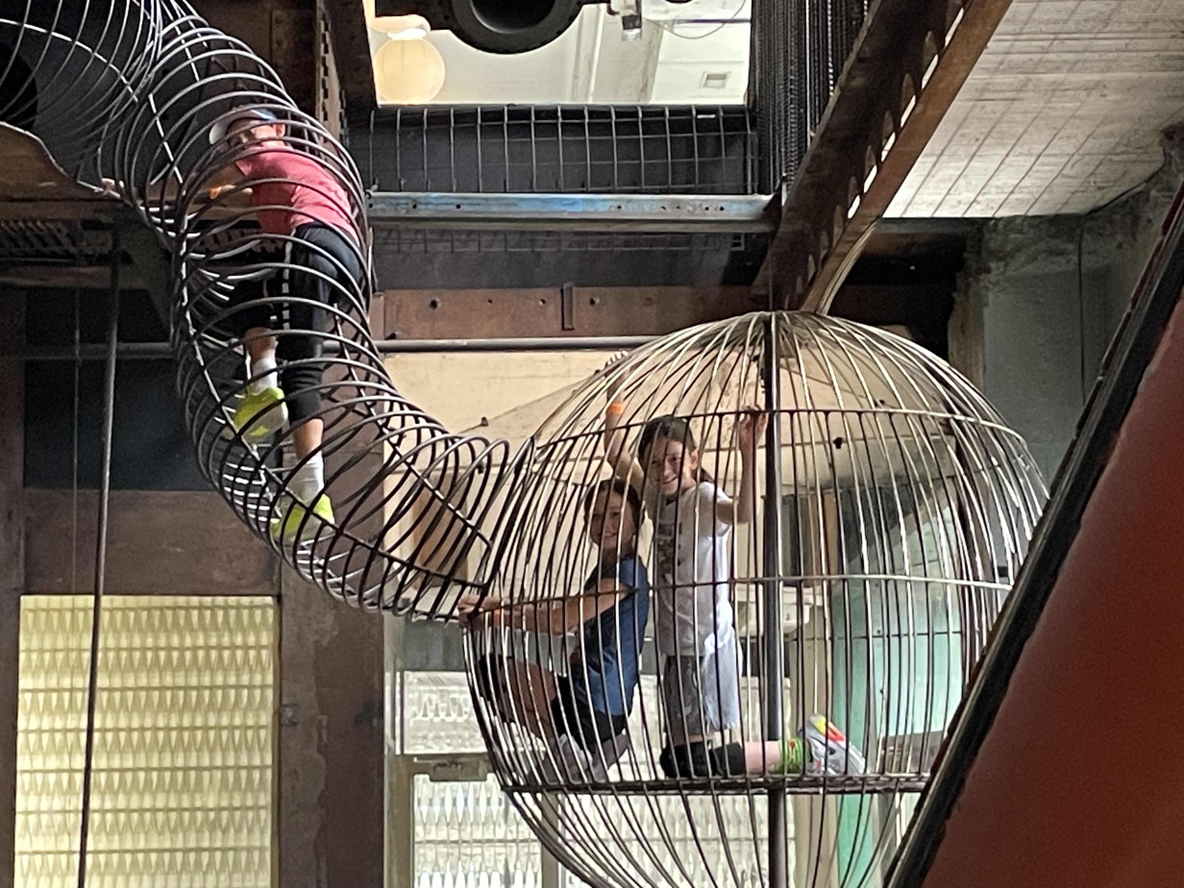 Children climbing through obstacle areas at City Museum in St. Louis Missouri