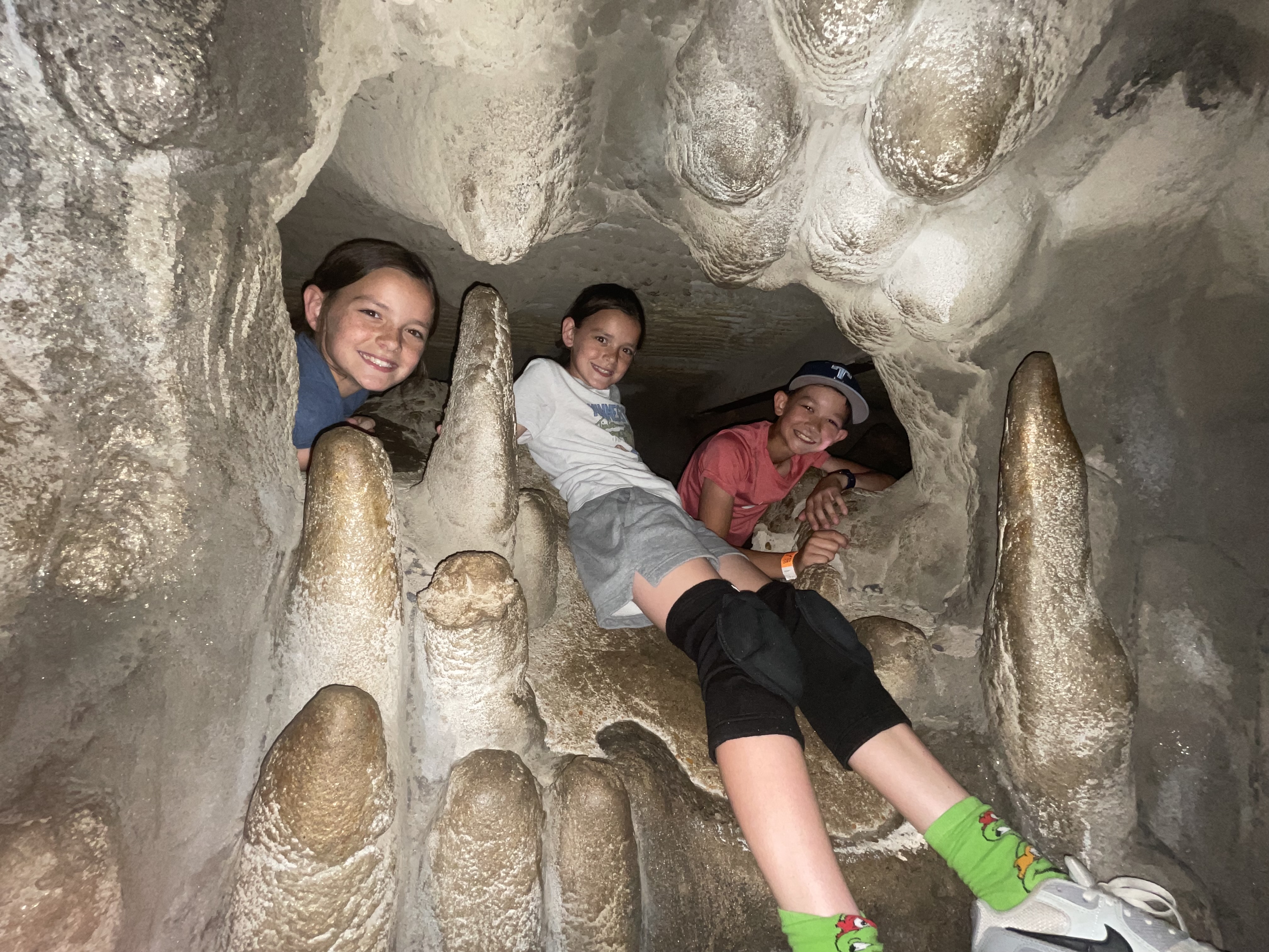 Children climbing through cave tunnels at City Museum in St. Louis Missouri