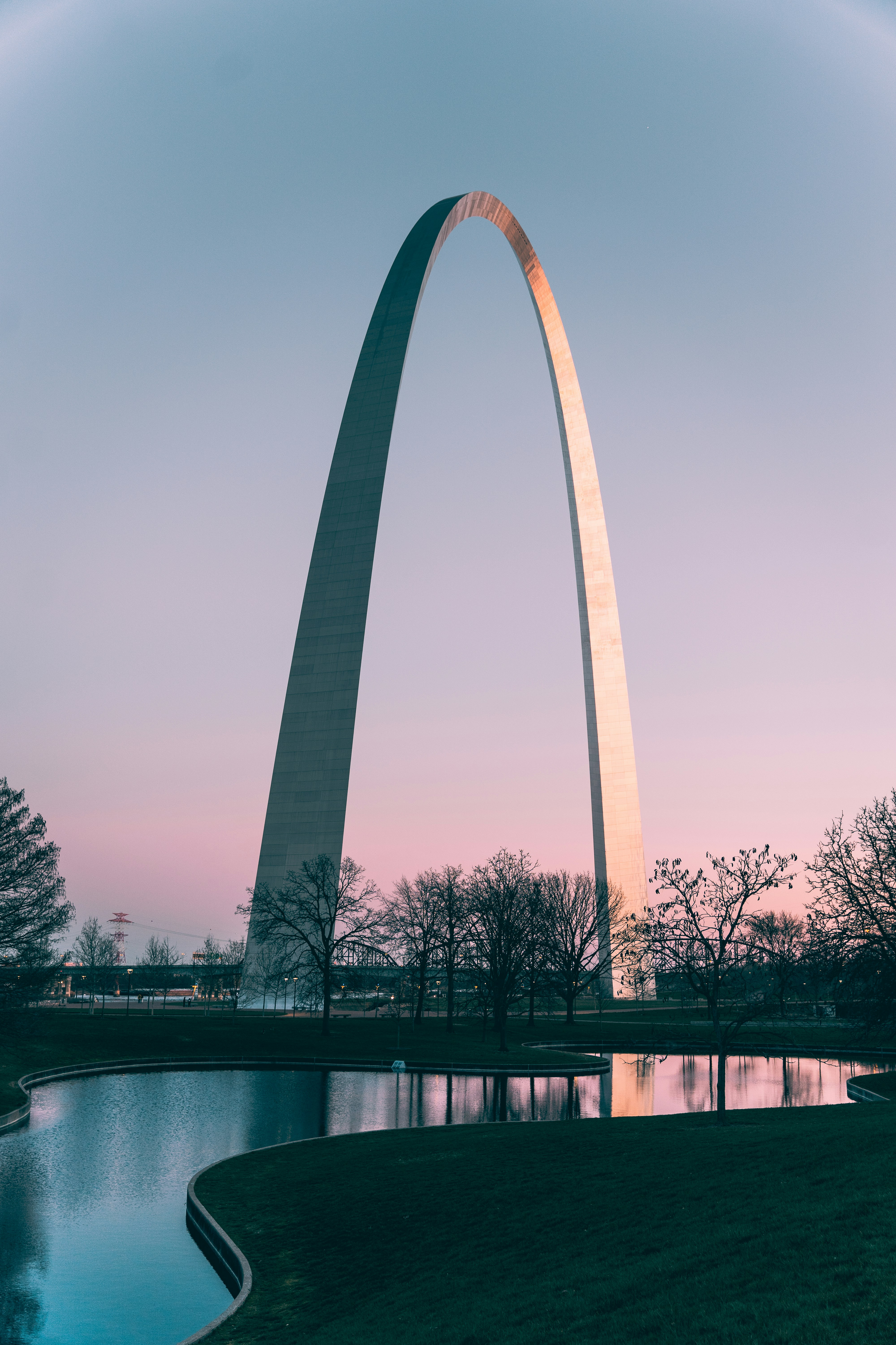 Gateway Arch reflected in water at sunset in St. Louis Missouri